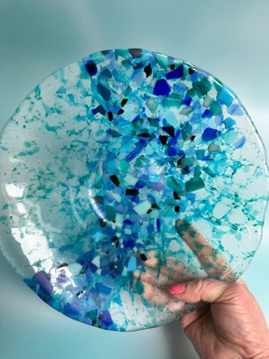 Fused glass bowl using offcuts of glass in blues and clear