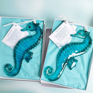 Fused glass hanging seahorses in shades of turquoise